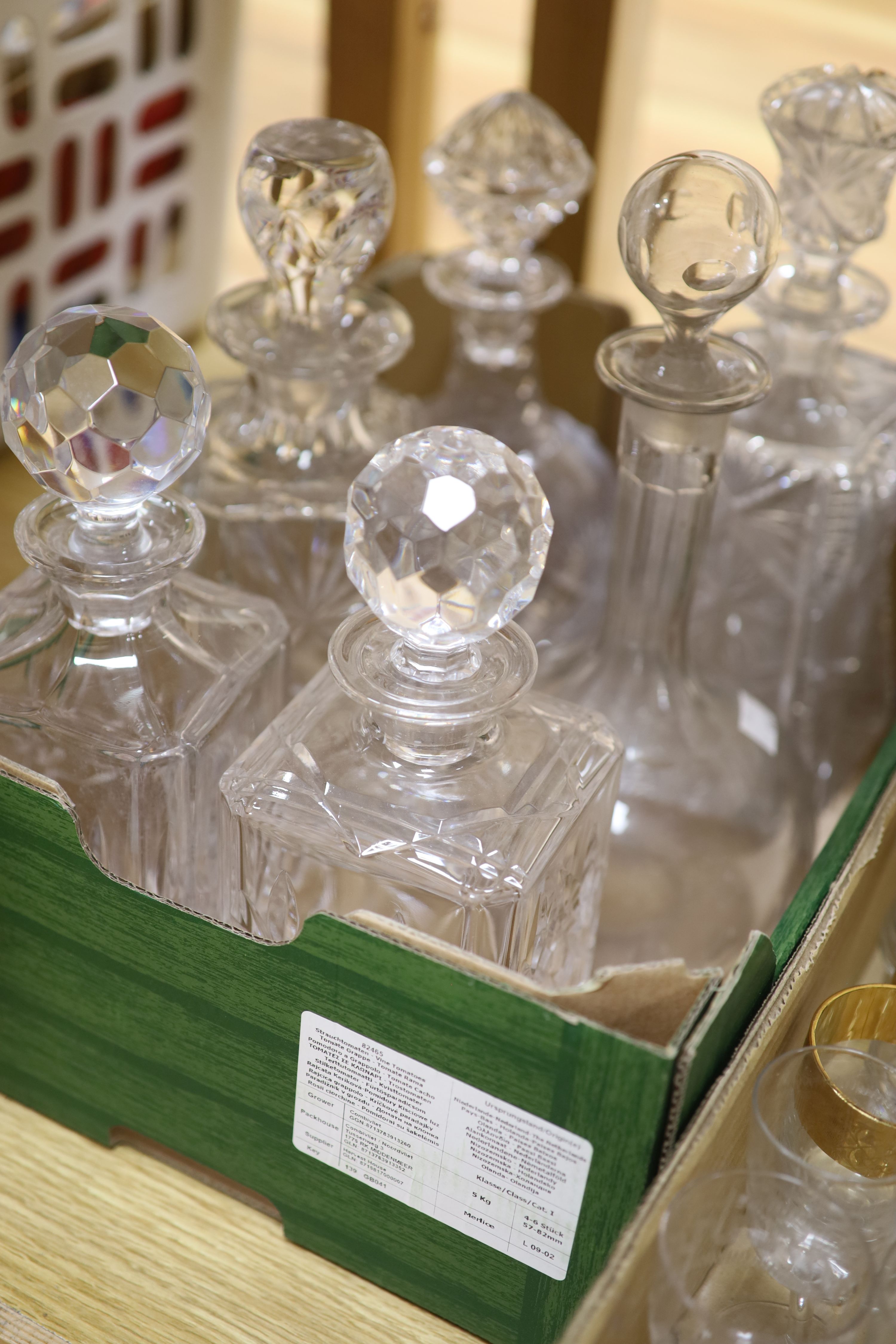 Eight cut glass decanters and mixed drinking glasses